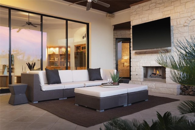 patio terrace at dusk with an outdoor living space with a fireplace and ceiling fan