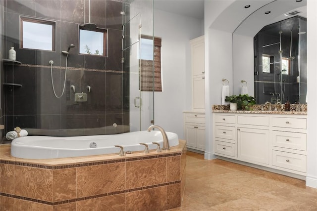 bathroom with vanity and separate shower and tub