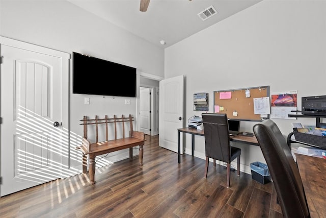 office space with ceiling fan, dark hardwood / wood-style floors, and a high ceiling