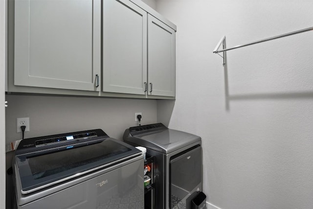 washroom with cabinets and separate washer and dryer