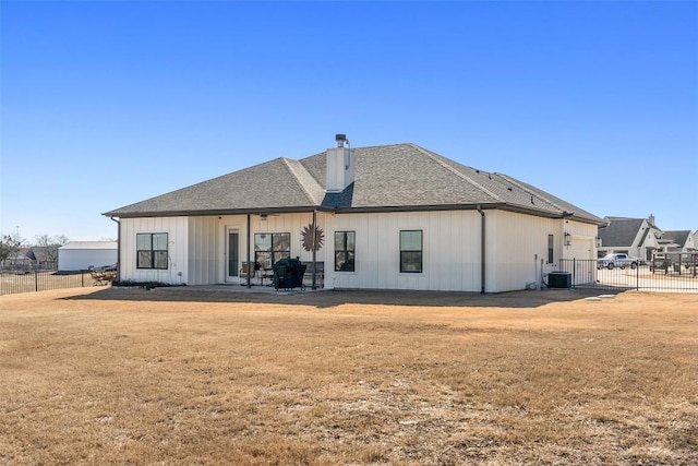 rear view of house with a yard and central air condition unit