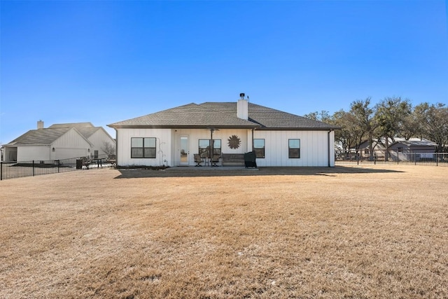 rear view of property featuring a yard