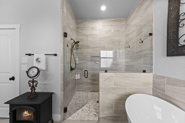 bathroom featuring plus walk in shower and a wood stove