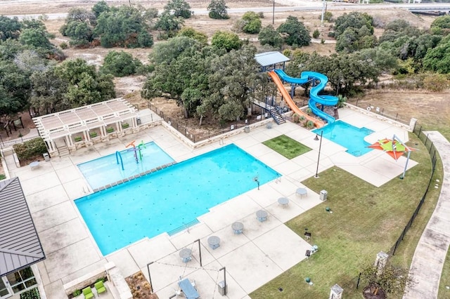 view of pool with a playground, a patio, and a water slide