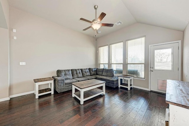 living room with dark wood-type flooring, ceiling fan, and vaulted ceiling