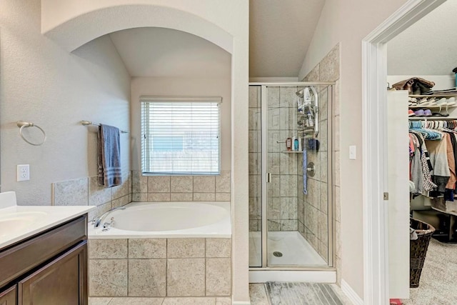 bathroom featuring vanity and independent shower and bath