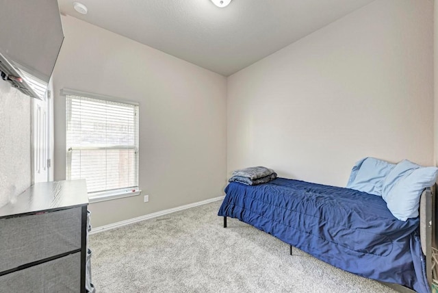 bedroom with light carpet and vaulted ceiling