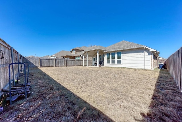 rear view of property with a yard