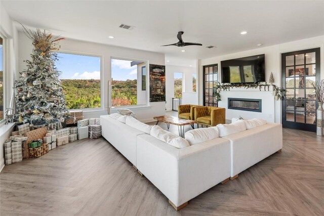 living room with parquet flooring and ceiling fan