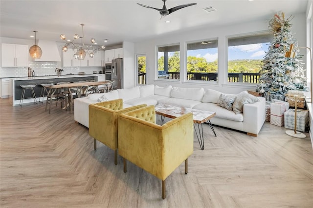 living room featuring ceiling fan and light parquet flooring