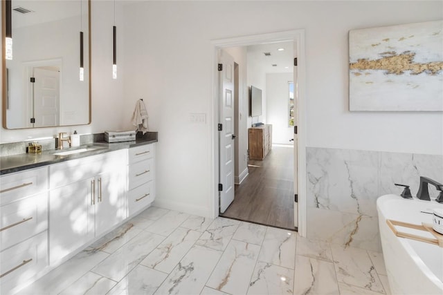 6200 Valleyview Dr, Lago Vista, TX 78645 - bathroom featuring visible vents, a freestanding bath, marble finish floor, and vanity
