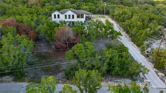 birds eye view of property featuring a view of trees