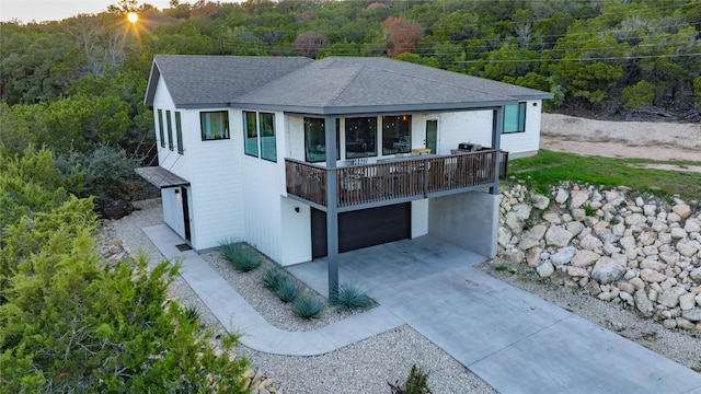 6200 Valleyview Dr, Lago Vista, TX 78645 - view of front of home featuring a garage, a view of trees, roof with shingles, and concrete driveway