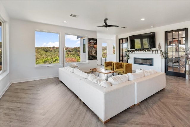6200 Valleyview Dr, Lago Vista, TX 78645 - living area featuring a glass covered fireplace, baseboards, a wealth of natural light, and visible vents