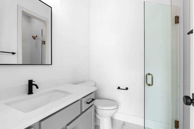 bathroom with vanity, an enclosed shower, and toilet