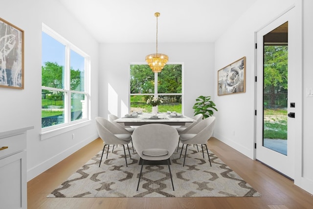 dining room featuring a notable chandelier and light wood-type flooring