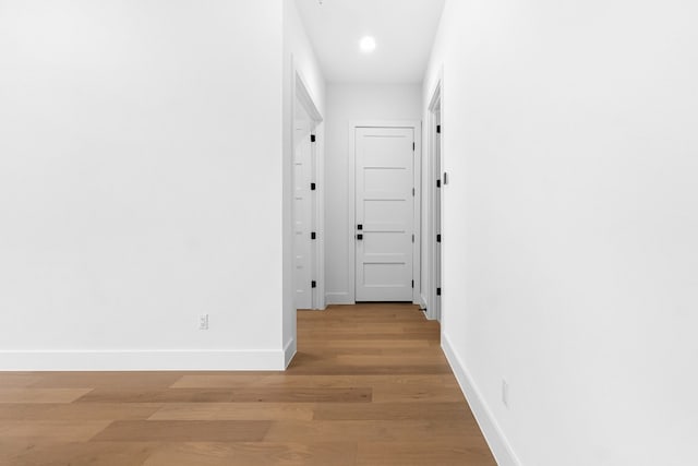 corridor featuring hardwood / wood-style floors