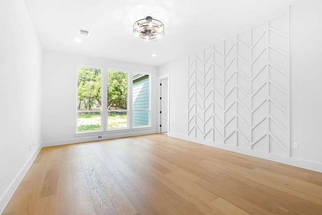 spare room featuring light wood-type flooring