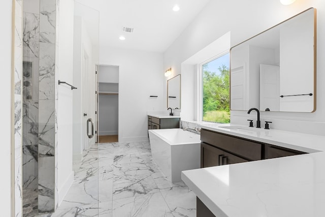 bathroom with vanity and independent shower and bath