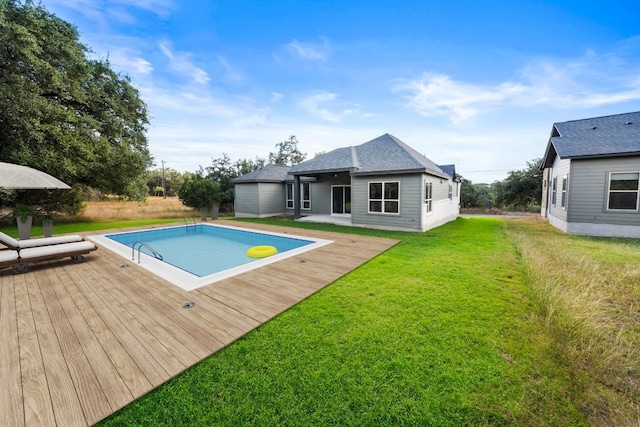 view of pool featuring a wooden deck and a lawn