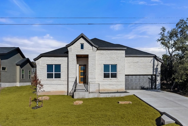 view of front of property with a garage and a front lawn