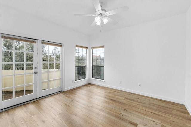 spare room featuring french doors, ceiling fan, and light hardwood / wood-style floors