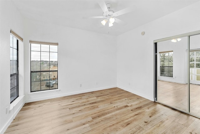 empty room with light hardwood / wood-style flooring and ceiling fan