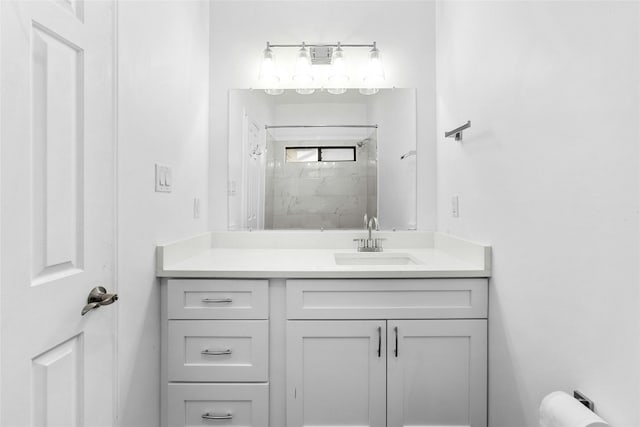 bathroom with vanity and tiled shower