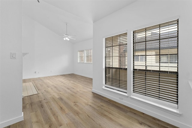 spare room featuring vaulted ceiling, ceiling fan, and light wood-type flooring