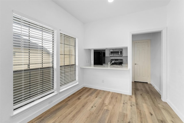 unfurnished room with light wood-type flooring