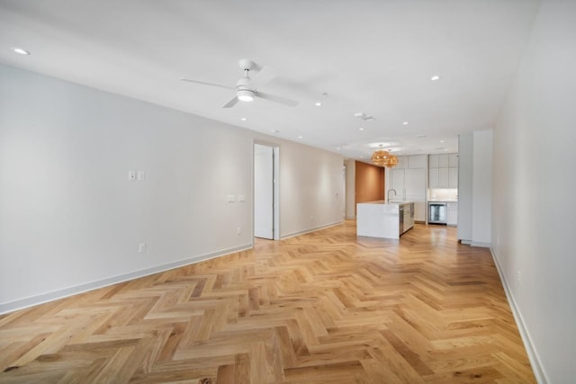 unfurnished living room featuring sink, light parquet floors, and ceiling fan