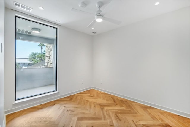 spare room featuring parquet floors and ceiling fan