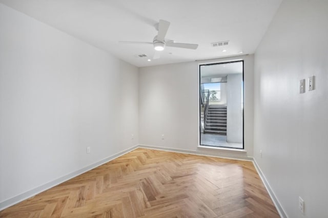 empty room featuring light parquet floors and ceiling fan