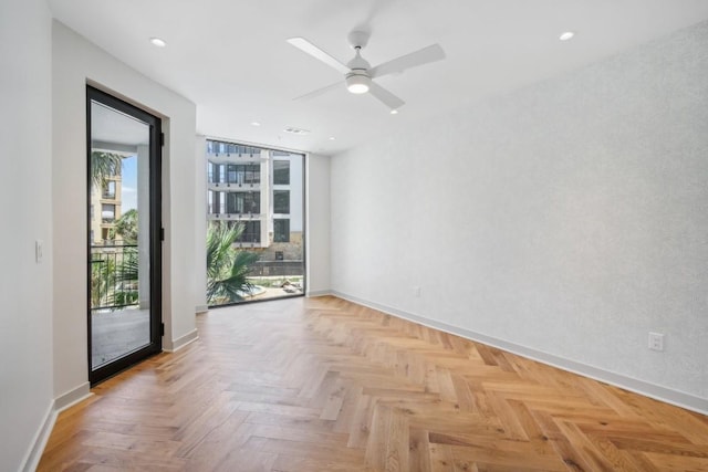 spare room featuring ceiling fan and light parquet floors