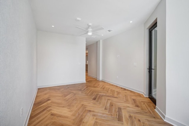 empty room featuring ceiling fan and light parquet flooring