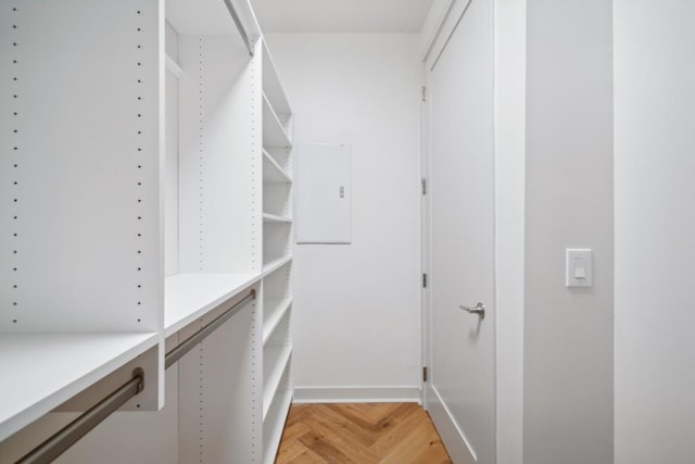 spacious closet featuring parquet floors