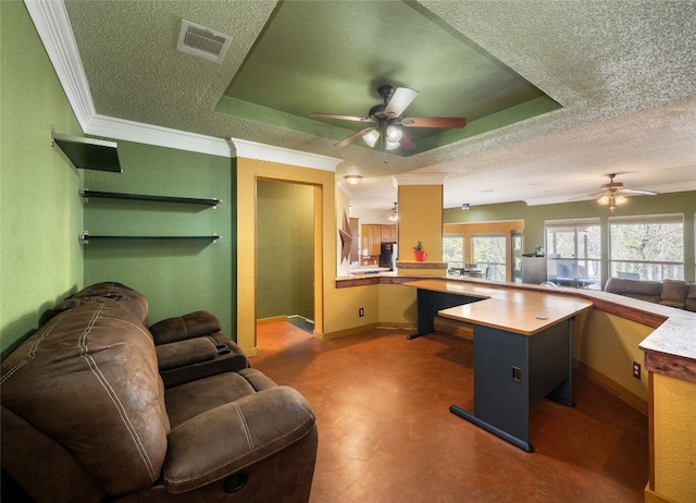 office featuring crown molding, ceiling fan, a tray ceiling, and a textured ceiling