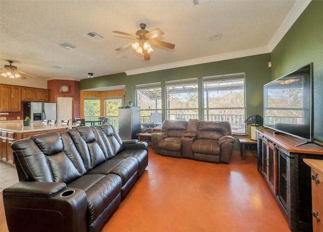 living room with ceiling fan and ornamental molding