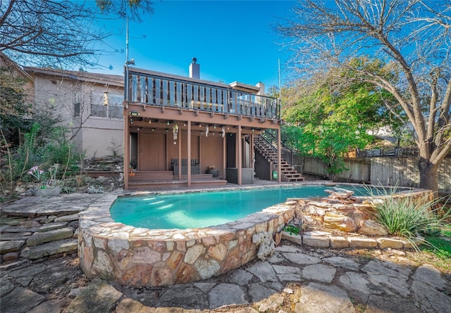 back of house with a swimming pool side deck