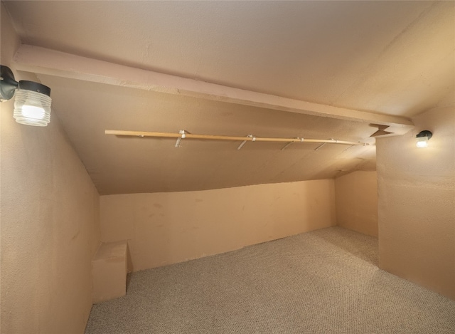 bonus room with carpet flooring and vaulted ceiling