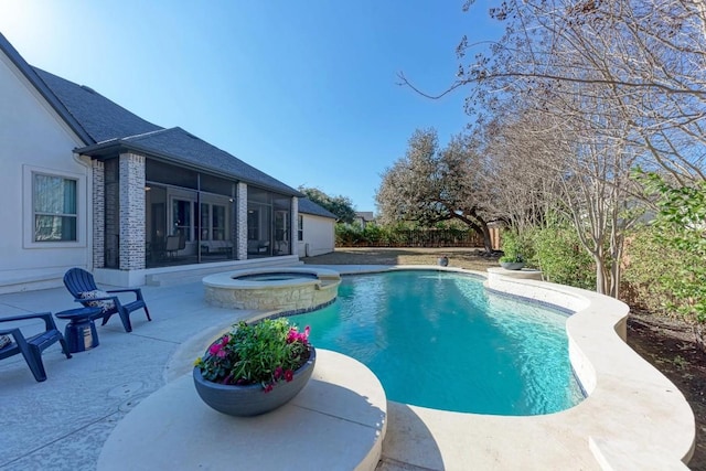 view of swimming pool with a patio area, a sunroom, and an in ground hot tub