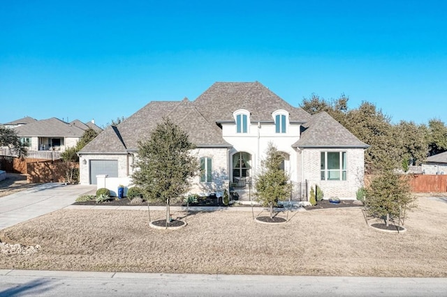 french country style house with a garage