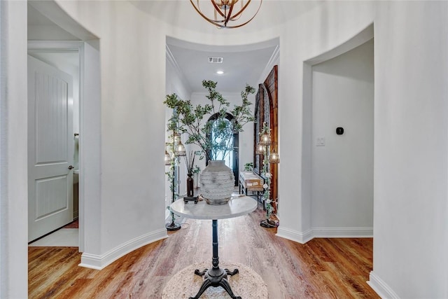 foyer featuring light hardwood / wood-style flooring and a notable chandelier