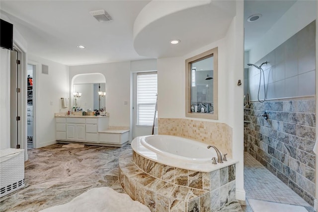 bathroom with independent shower and bath and vanity