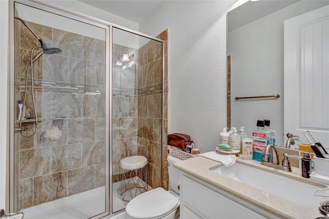 bathroom featuring vanity, an enclosed shower, and toilet