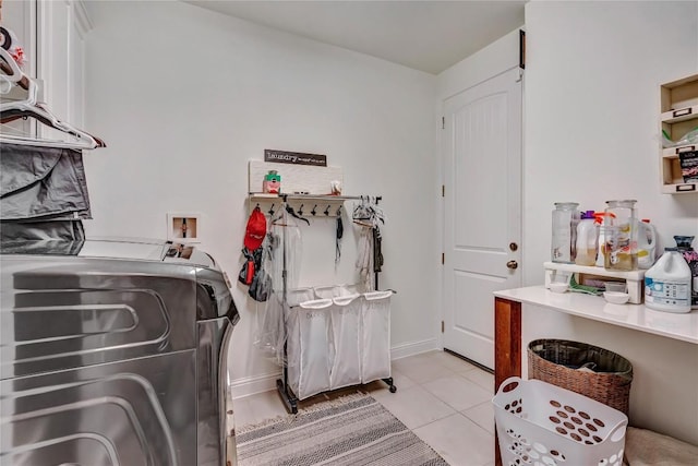 laundry room with light tile patterned flooring and washing machine and dryer