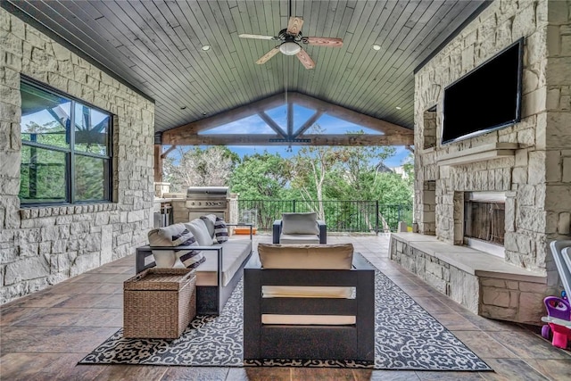 view of patio / terrace with ceiling fan, grilling area, and an outdoor living space with a fireplace