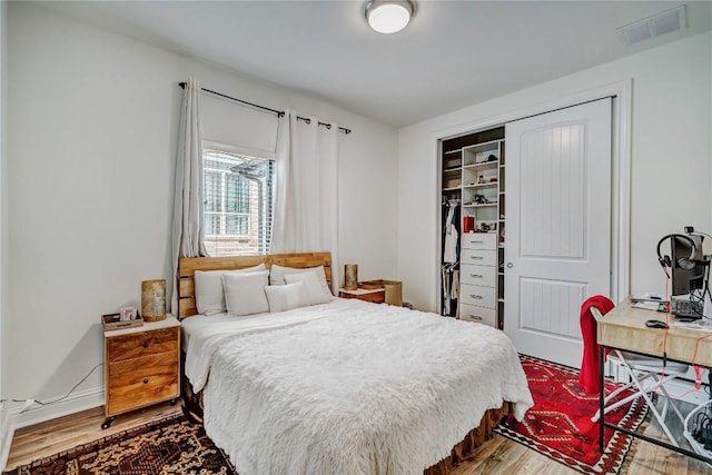 bedroom with hardwood / wood-style flooring and a closet