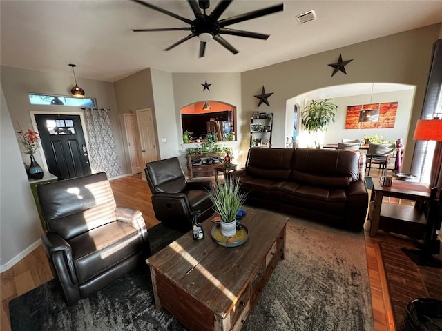 living room featuring hardwood / wood-style flooring and ceiling fan