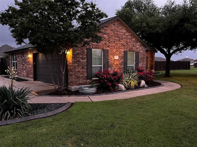 view of front of home featuring a garage and a lawn